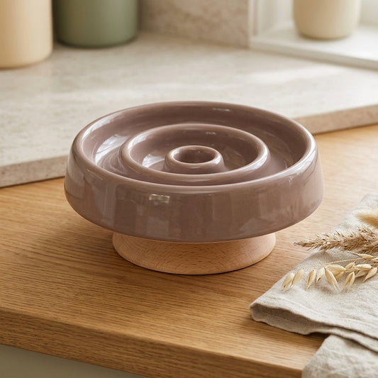 WilderPaw HearthBowl raised ceramic slow-feeder dog bowl in brown on a natural wood stand